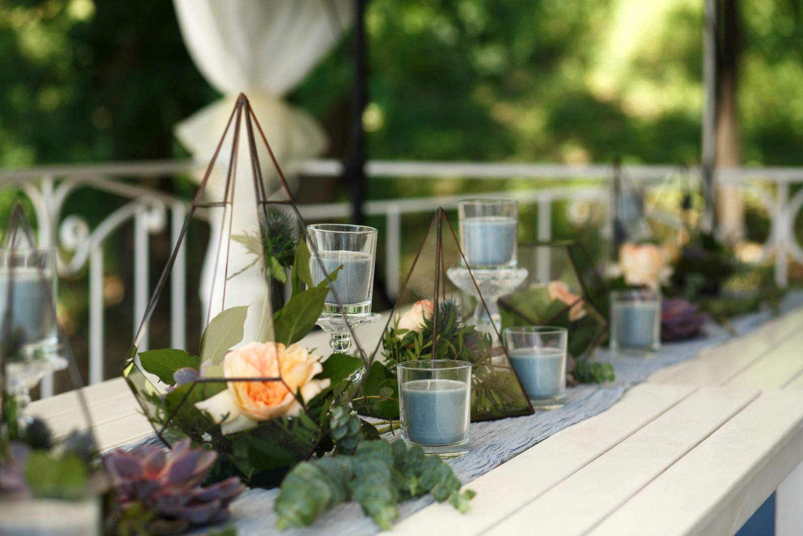 Florarium with fresh succulent and rose flowers festive table decoration. Event fresh flowers decoration. Florist workflow. Wedding ceremony  design
