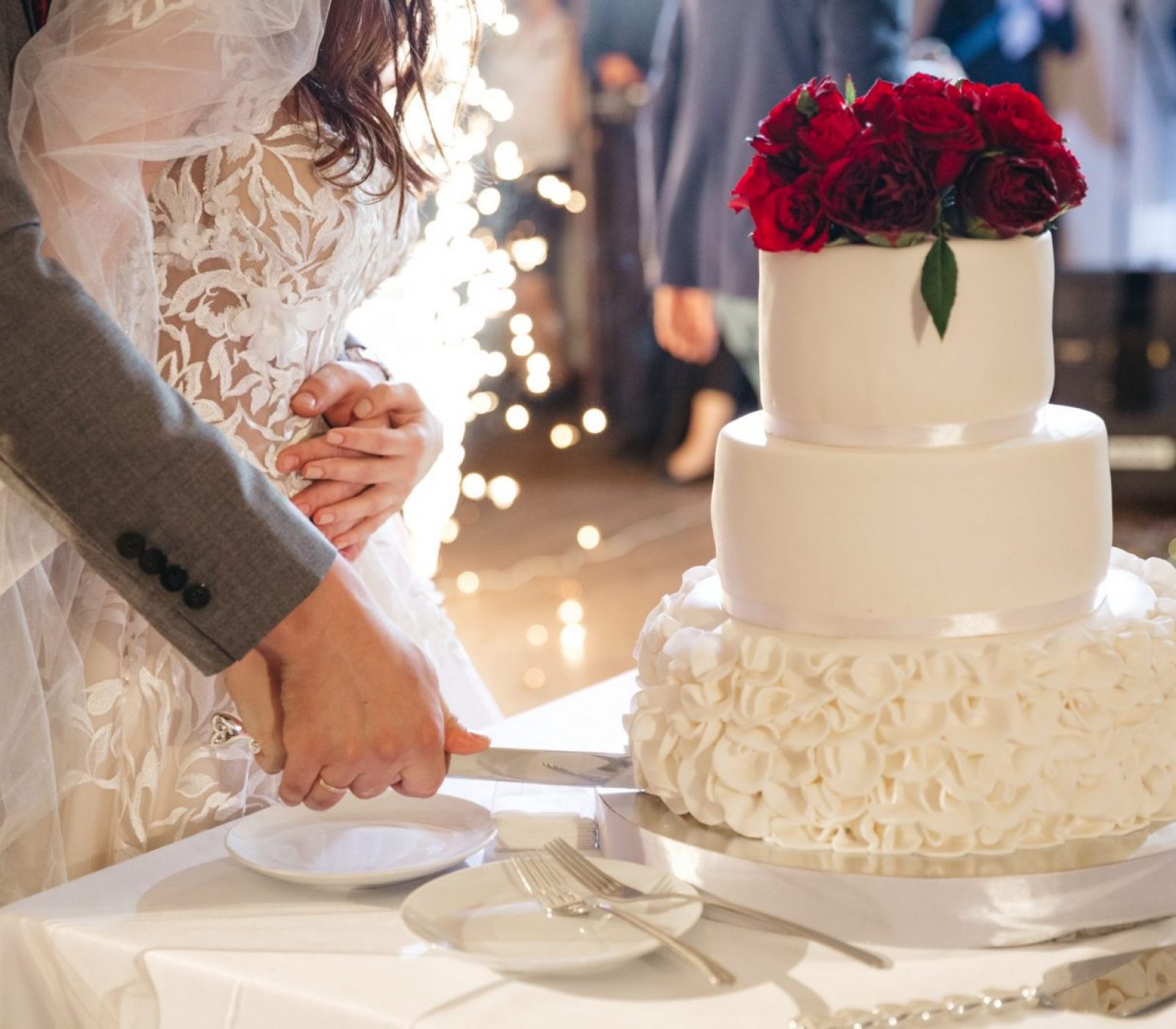 Happy bride and groom cut a wedding cake